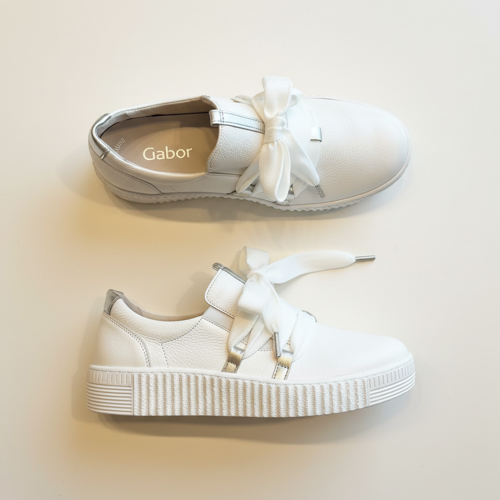 White sneakers with bows on a light background, featuring the brand 'Gabor'.