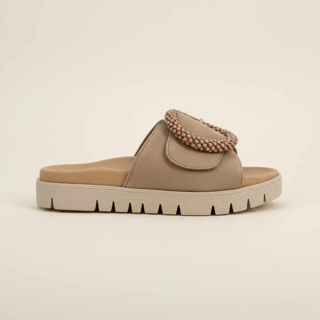 Beige sandal with a textured strap on a beige background