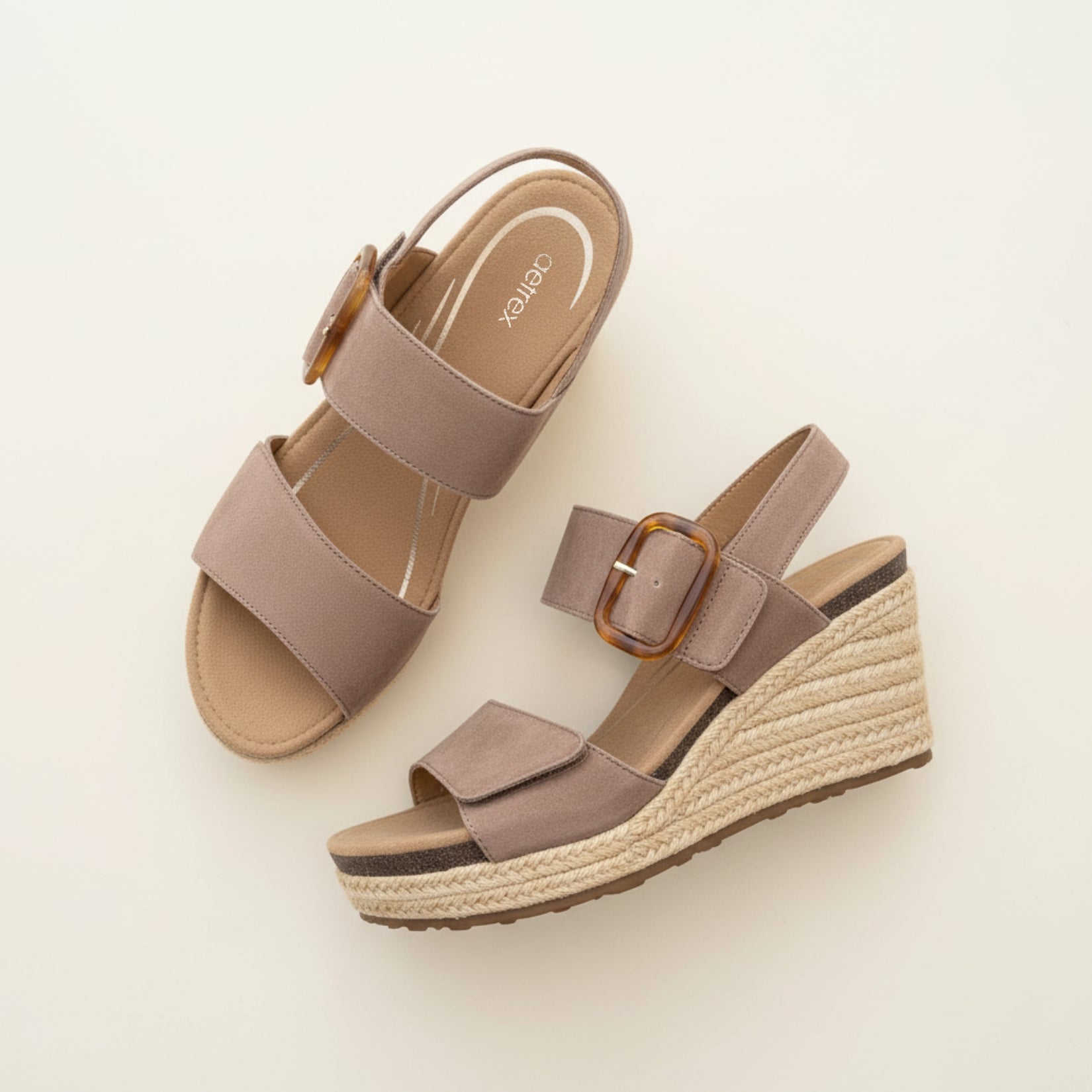 Pair of brown wedge sandals with espadrille sole on a light beige background