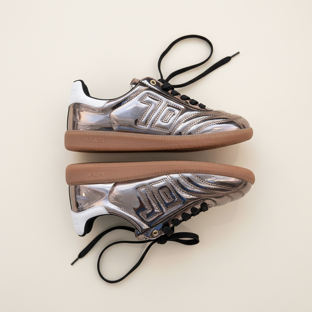 Pair of silver and brown sneakers on a light beige background