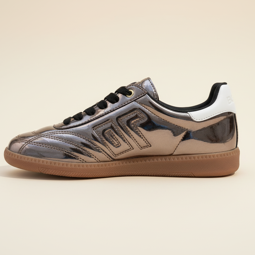 Shiny sneaker with a distinctive logo on a beige background