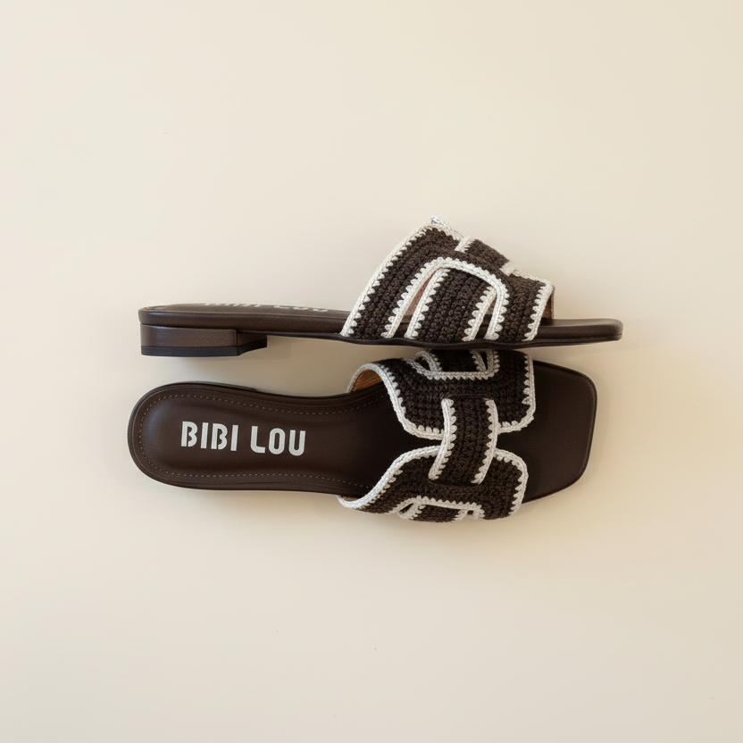Black and white sandal with 'BIBI LOU' branding on a beige background