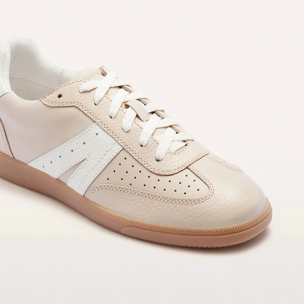 Beige sneaker with white accents on a light background