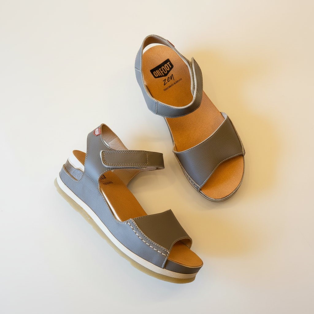 Pair of gray and brown sandals on a gradient background