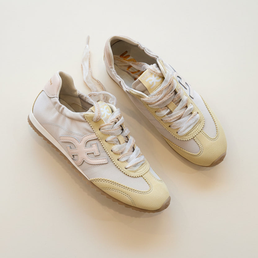 Pair of pastel-colored sneakers on a light background