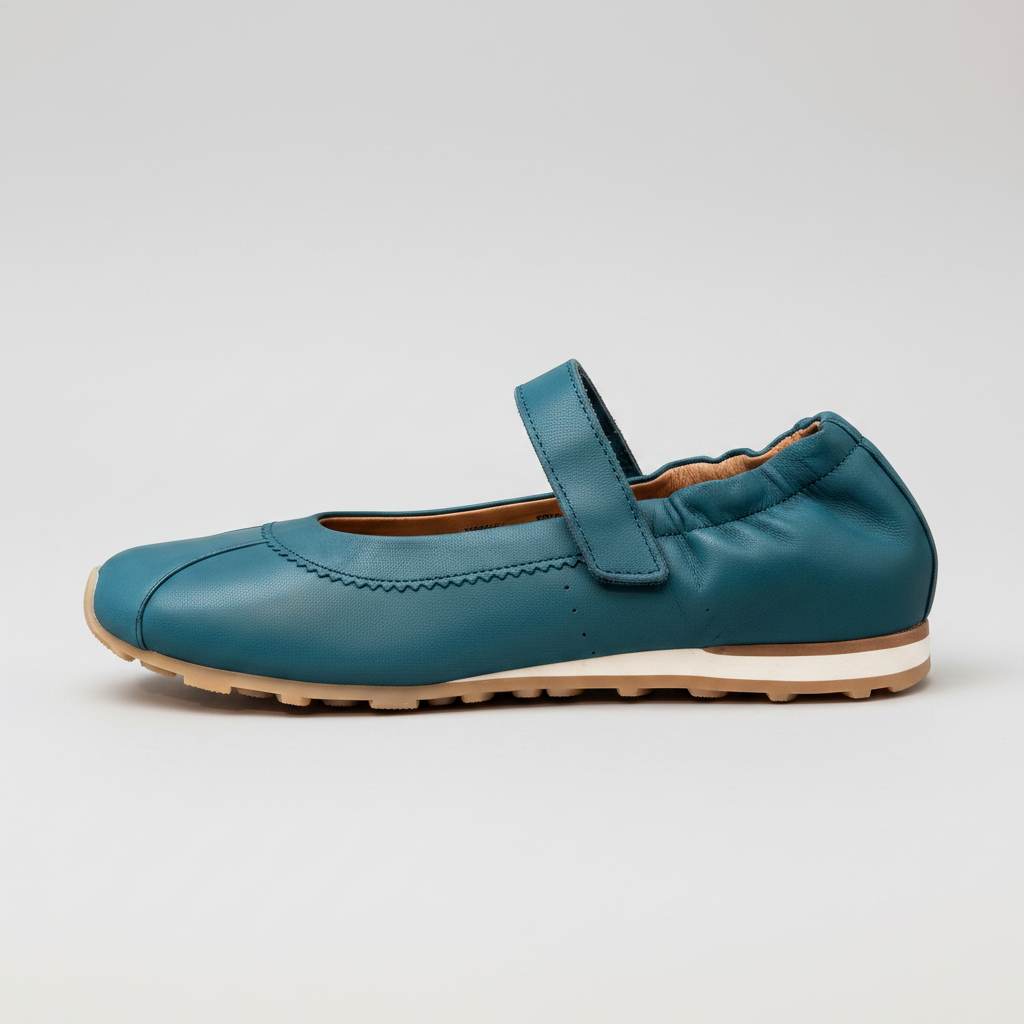 A teal blue leather Mary Jane flat shoe with a hook-and-loop strap, shown in profile against a light gray background.