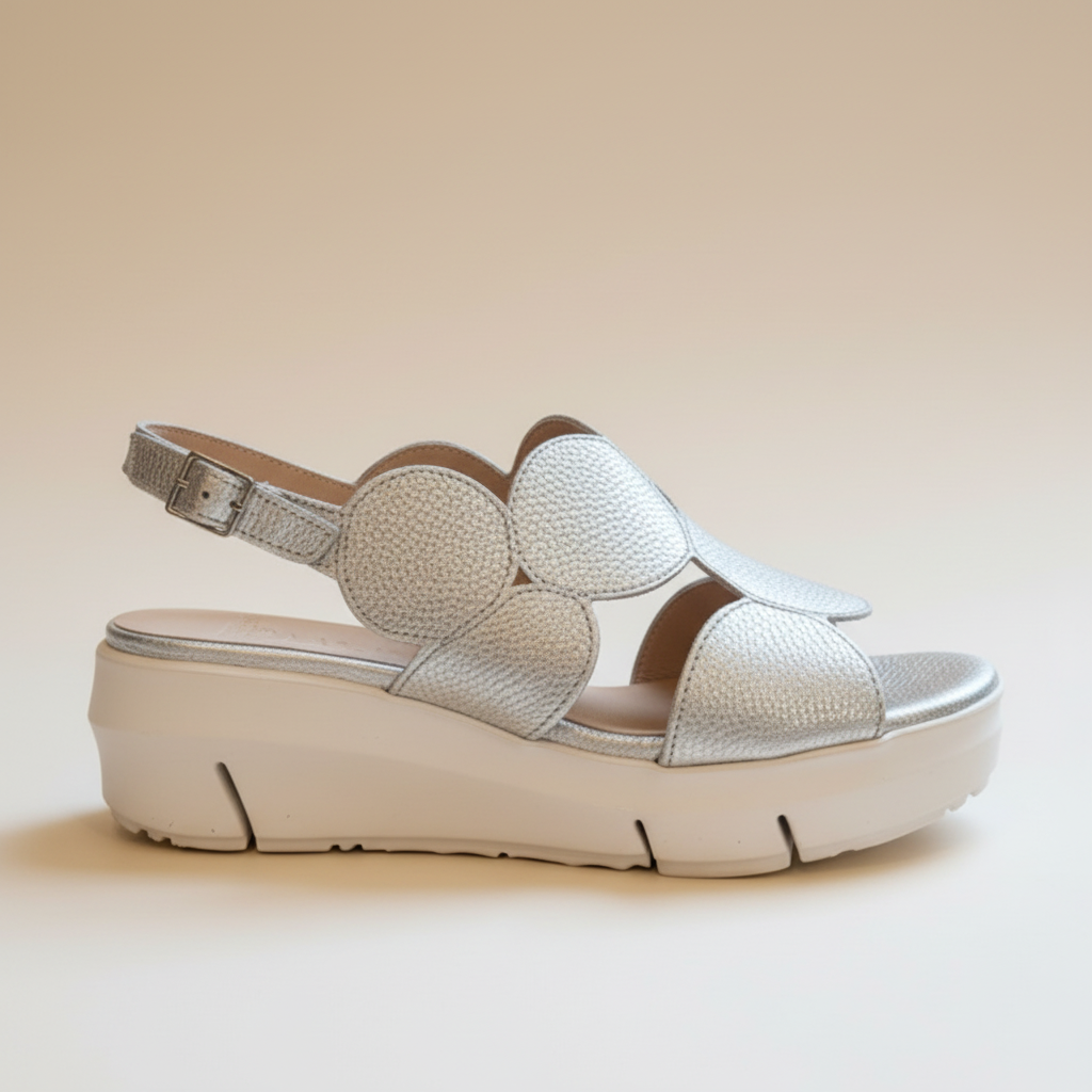 Silver sandal with a platform sole on a beige background