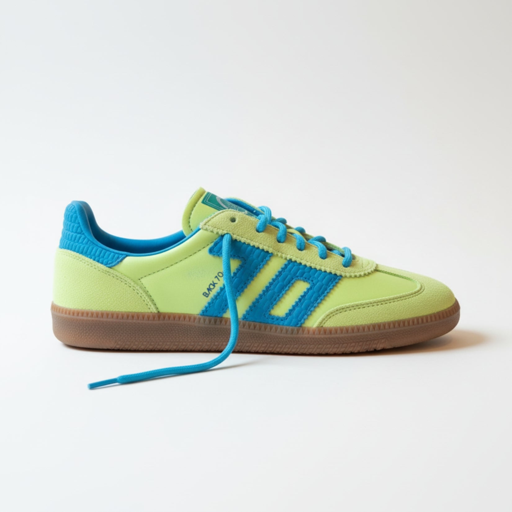 Green and blue sneaker with brown sole on a white background