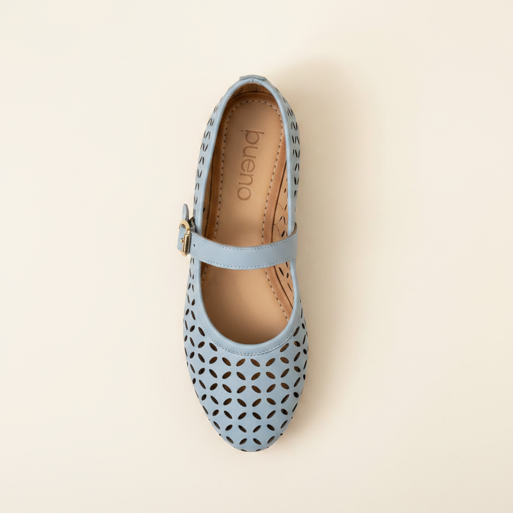 Light blue flat shoe with cut-out design on a beige background