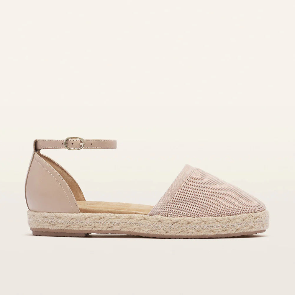 Pink espadrille shoe on a light beige background