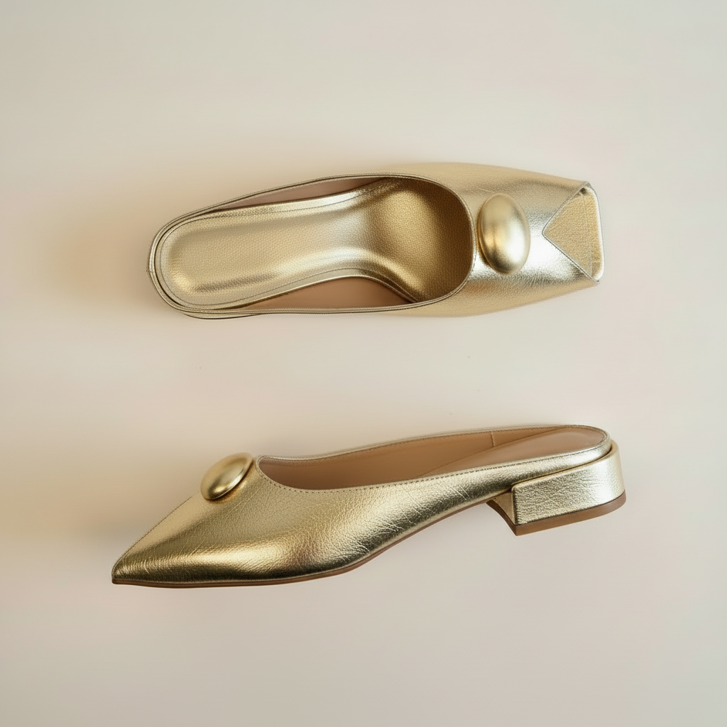 Gold pointed-toe shoes on a beige background