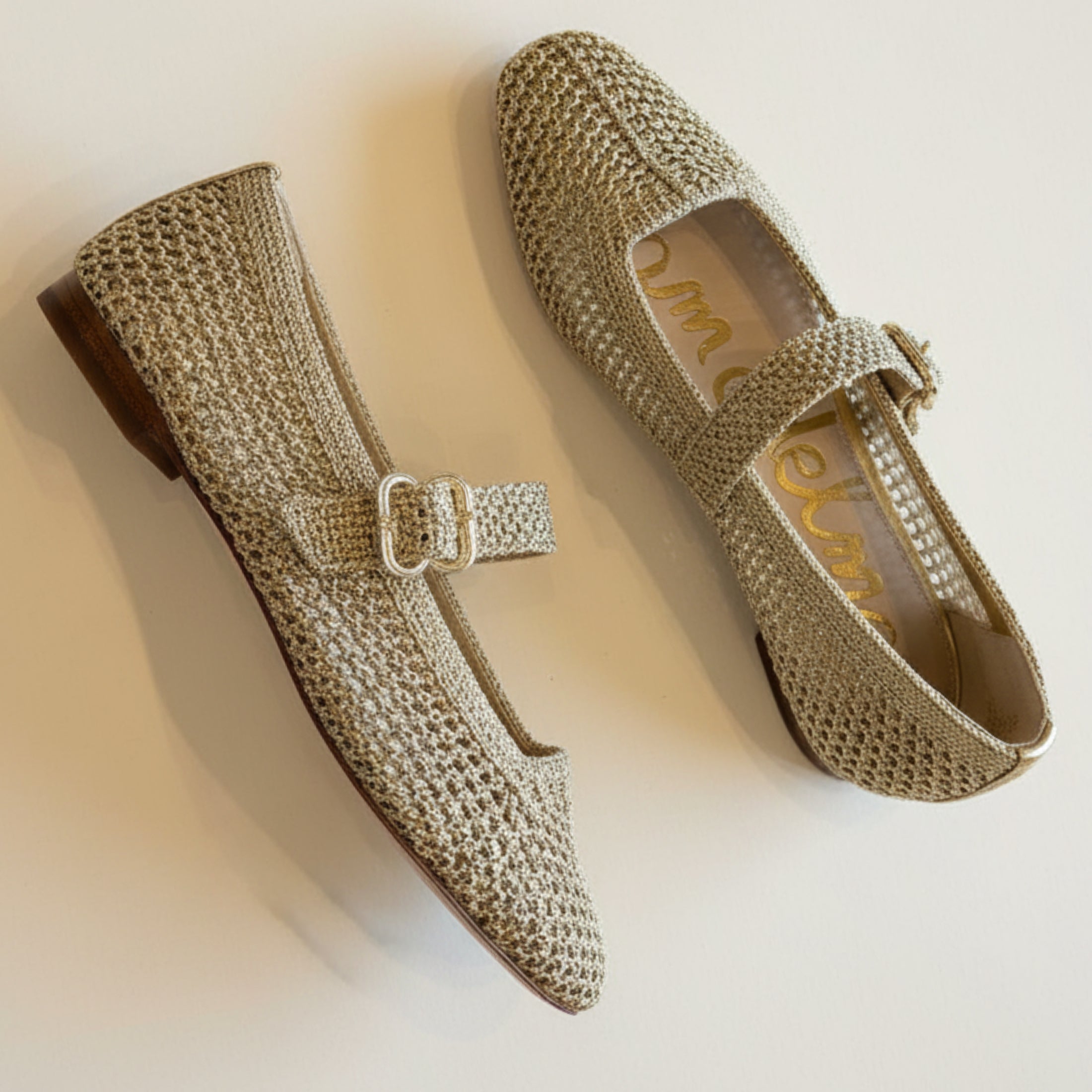 Pair of woven shoes with a buckle on a light background