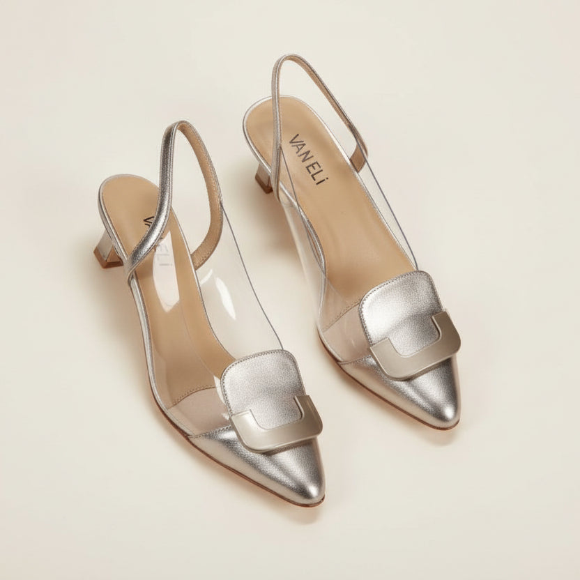 Pair of silver high-heeled shoes on a light gray background